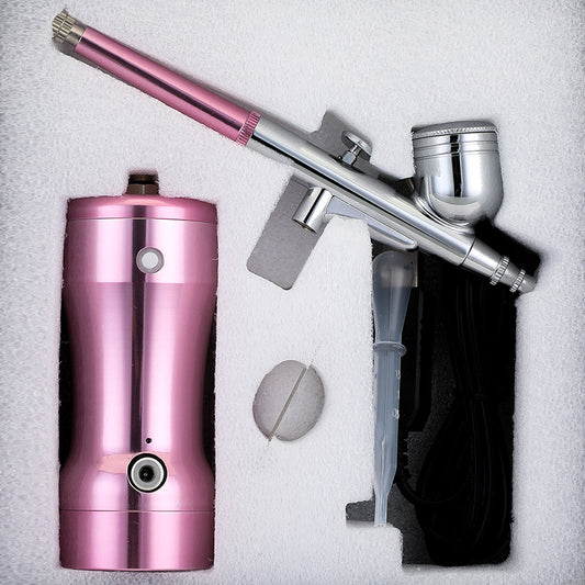 Manicure. Beauty. Cake coloring. Hand-held air pump charging portable airbrush